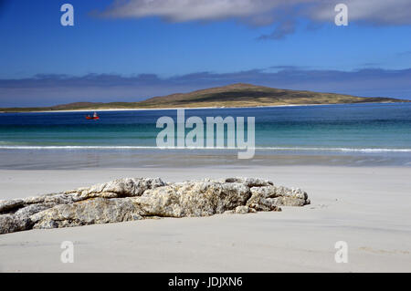 A Small Red Fishing Boat Passing West Beach on the Island of Berneray on North Uist with the Island of Pabbay in the Background, Outer Hebrides, Stock Photo