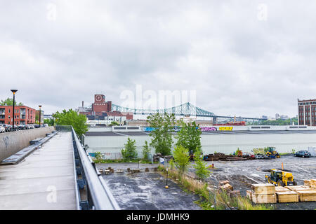 Montreal, Canada - May 26, 2017: Molson Beer sign with Jacques Cartier bridge in city in Quebec region during rainy cloudy wet day Stock Photo