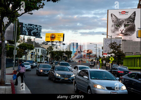 Lit billboards on the Sunset Strip in Los Angeles at dusk. Stock Photo