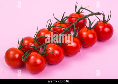 Organic cherry tomatoes on pink background. Studio Photo Stock Photo