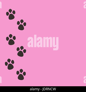 Black animal paws prints on a pink background with empty space for text. Stock Photo