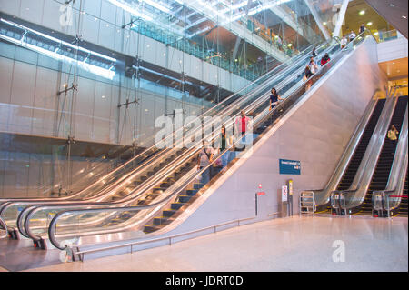 SINGAPORE - JAN 13, 2017 : Escalators at Changi International Airport in Singapore. Changi Airport serves more than 100 airlines operating 6,100 weekl Stock Photo