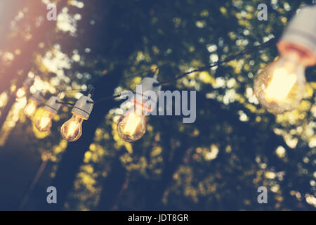 hanging decorative string lights for outdoor party Stock Photo