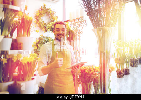 man with tablet pc computer at flower shop Stock Photo