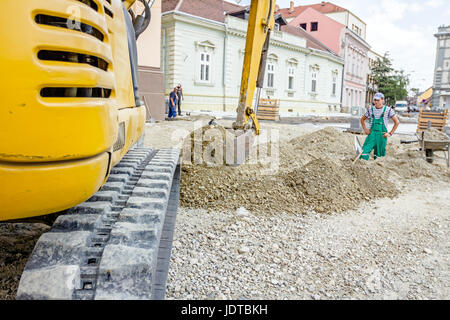 Small excavator is excavating soil at construction site, project in progress. Stock Photo