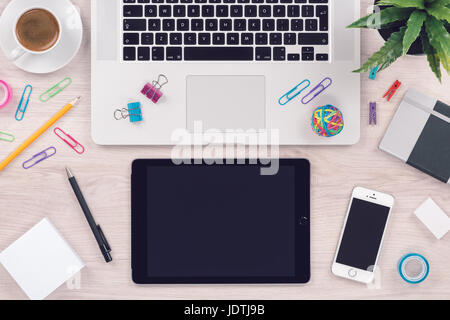 Office desk table workplace with laptop keyboard tablet pc and smartphone top view Stock Photo