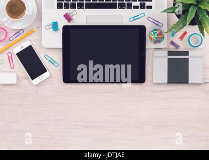 Office desk table workplace with laptop tablet smartphone notebook top view with copy space Stock Photo