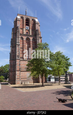 old lopsided tower oldehove tower and dog in the centre of leeuwarden, capital of friesland, in the netherlands with blue sky Stock Photo