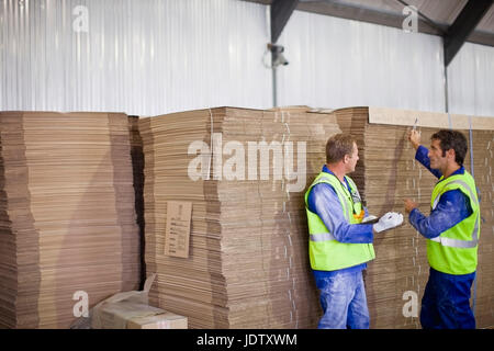 Workers talking in factory Stock Photo