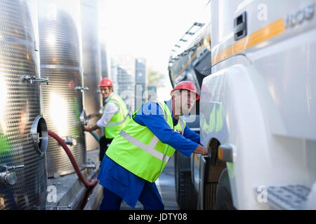 Workers filling trucks with gas Stock Photo