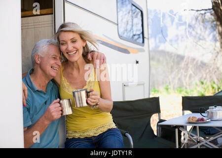 Older couple camping with RV Stock Photo