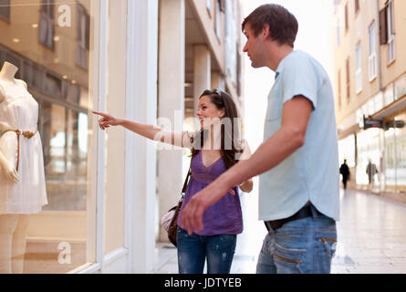 Woman window shopping with boyfriend Stock Photo