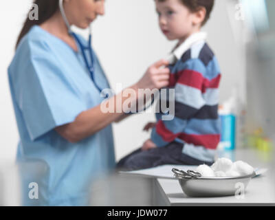 Nurse examining boy in doctors office Stock Photo