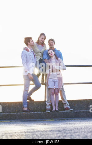 Couples standing at railing outdoors Stock Photo