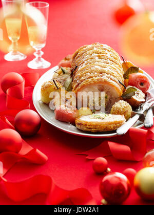 Plate of stuffed roast pork and fruit Stock Photo