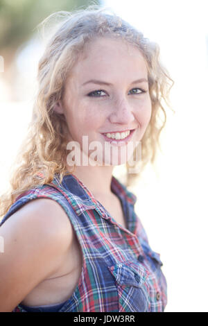 Portrait of young woman wearing checked shirt Stock Photo