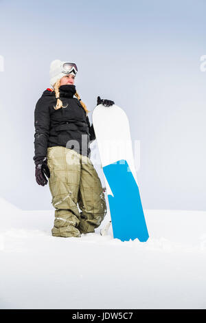 Portrait of young female with snowboard, Reutte, Tyrol, Austria Stock Photo