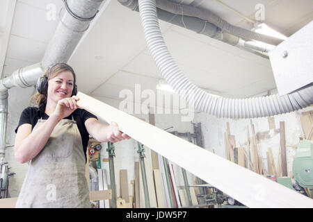Female carpenter working in workshop Stock Photo