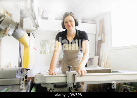 Female carpenter working in workshop Stock Photo