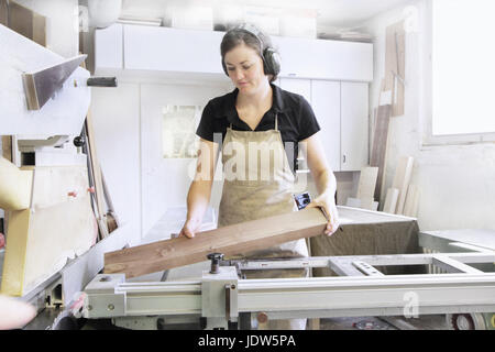 Female carpenter working in workshop Stock Photo