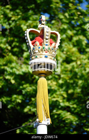 A crown embellishment on top of a flag pole holding a union flag during Trooping the Colour 2017 in The Mall, London, UK Stock Photo
