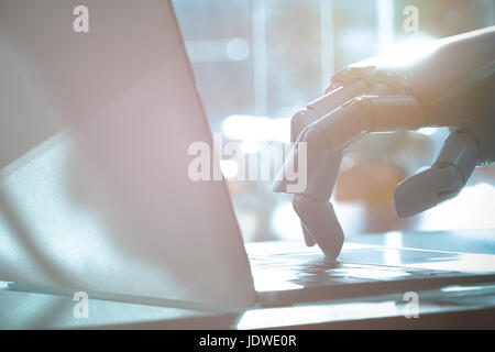 Robot finger point to laptop button. Chat bot , artificial intelligence , robo advisor , robotic concept. Stock Photo