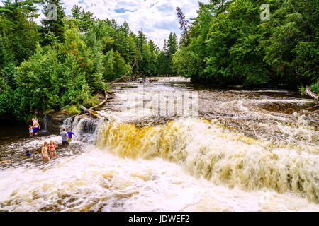 Tahquamenon Falls State Park. Michigan, August 9, 2016: Vacationers are swimming in Lower Tahquamenon Falls on a beautiful summer day Stock Photo