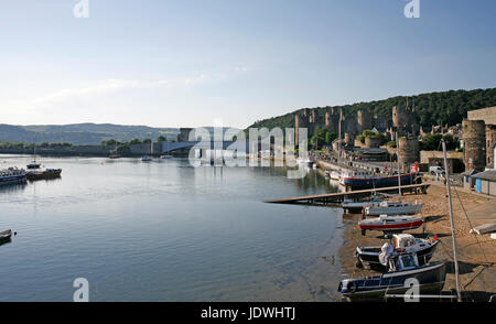 View of Conwy quay and the harbour showing the Castle and bridges across the river. Stock Photo