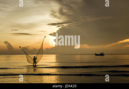 Sea clam digging fishermen golden sunrise Tan Thanh beach Go Cong Tien Giang Viet Nam Stock Photo