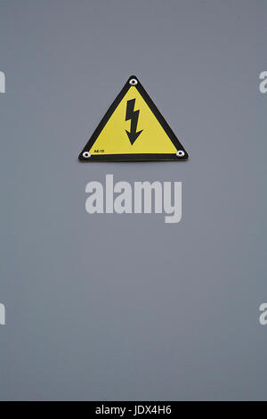 Signal of danger of electrocution from high voltage isolated in grey Stock Photo