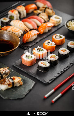 Sushi set rolls served on stone slate