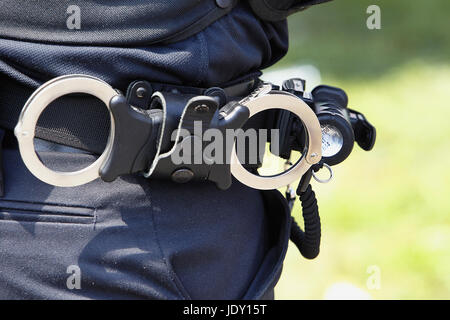 Law & Order, Police officers belt with handcuffs. Stock Photo