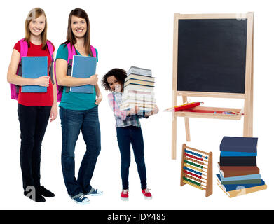 Students carrying textbooks and backpack Stock Photo