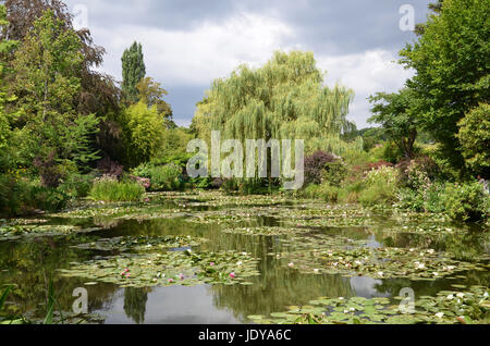 GIVERNY, FRANCE - AUG 5:  A weeping willow can be seen across the pond in the garden of Claude Monet in Giverny, France, on August 5, 2016. Stock Photo