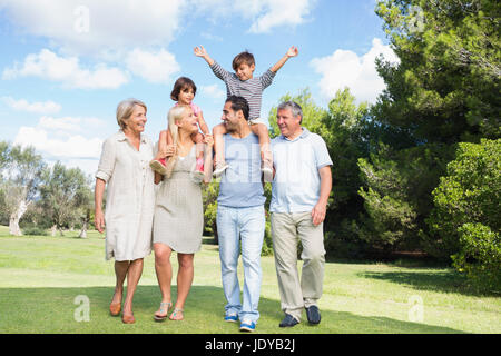 Happy multi-generation family strolling through the park Stock Photo