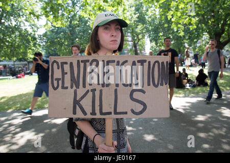 London, UK. 21st June, 2017. A Woman holds a placard 'Gentrification kills' during an anti-government protest to coincide with the State opening of Parliament and following the deadly fire at Grenfell Tower. Credit: Thabo Jaiyesimi/Alamy Live News Stock Photo