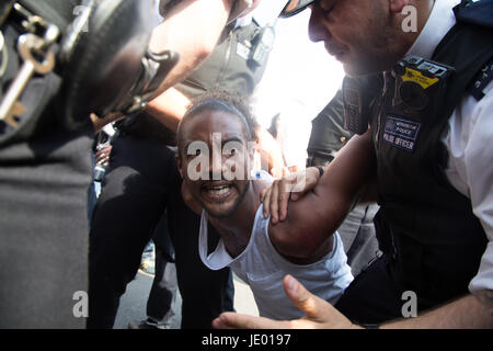 London, UK. 21st June, 2017. A man is arrested by police officers as protesters gather in Parliament Square after marching through central London during an anti-government protest to coincide with the State Opening of Parliament and following the deadly fire at Grenfell Tower. Credit: Thabo Jaiyesimi/Alamy Live News Stock Photo