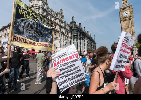 June 21, 2017 - London, UK - London, UK. 21st June 2017. The peaceful 'Day of Rage' march organised by Movement for JUstice ended here in Parliament Square, MfJ are calling for an Amnesty with all Grenfell survivors with insecure immigration status or without documents to be granted indefinite leave to reamin. Most will have lost all of their records in the fire. There were more speeches and chanting on the street with protesters ignoring police requests to clear the road. After around 20 minutes most of the protesters moved as requested onto the grass of Parliament Square where protests conti Stock Photo