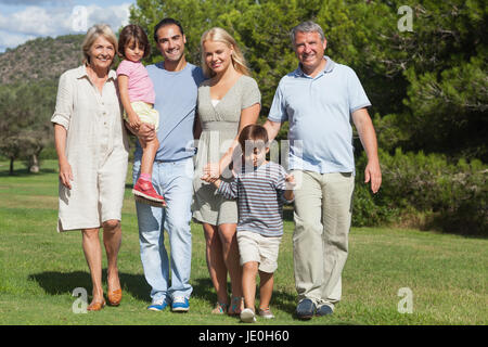 Multi-generation family portrait strolling through the park on a sunny day Stock Photo