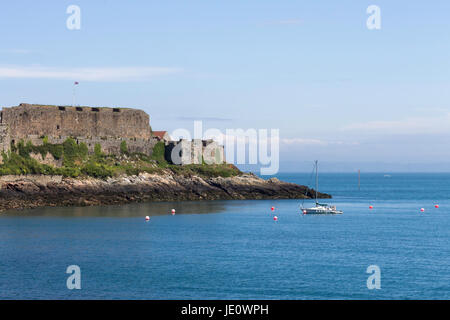 View of Castle Cornet, Saint Peter Port, Guernsey with Yacht in Foreground Stock Photo