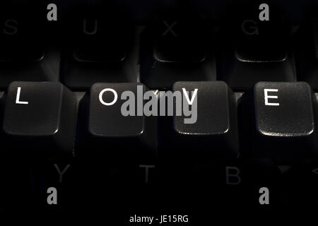 PC computer keyboard with the letters arranged to spell the word love conceptual use for online dating Stock Photo