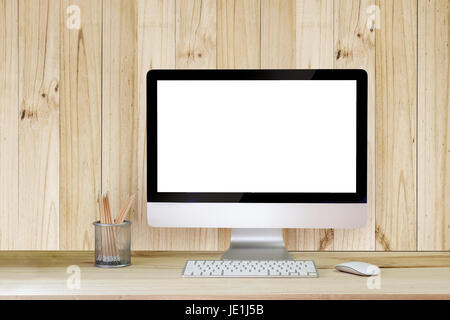 Creative hipster desktop with blank white computer screen, coffee cup and other items on wood background. Mock up workspace. Stock Photo