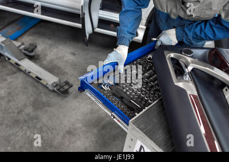 The mechanic selects the tool. tools for service station. spanners and socket nozzles