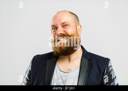 Laughing brutal man with beard on empty gray background Stock Photo
