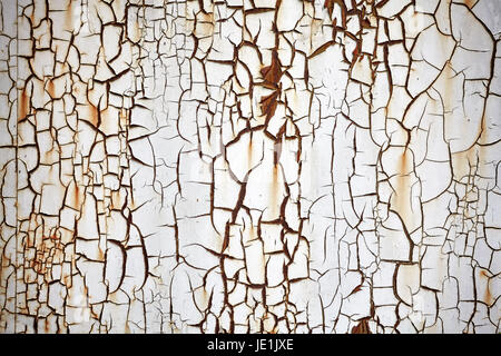 Rusty metal wall with peeling white paint, grunge background or texture. Stock Photo