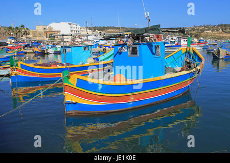 Colourful traditional fishing boats called luzzu in the harbour at Marsaxlokk, Malta Stock Photo