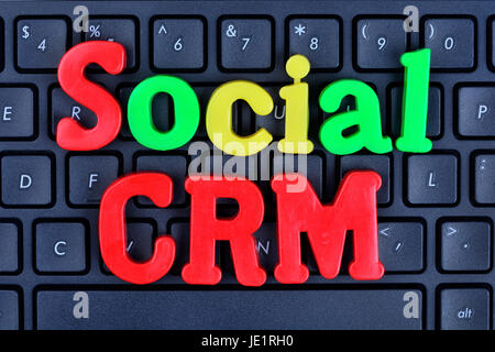 Social CRM words on computer keyboard closeup Stock Photo