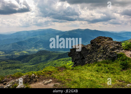 huge stone on the edge of a hill. beautiful valley view from the top Stock Photo