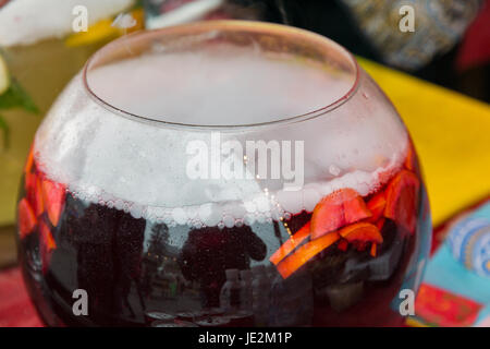 A big tank of red sparkling sangria wine with fruit outdoor closeup Stock Photo