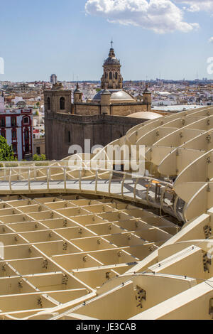 SEVILLE, SPAIN - MAY 2014: Panoramic view in the top of Metropol Parasol in Plaza de la Encarnacion on 31 of May 2014 in Sevilla,Spain. the extraordinary new Seville Market Hall an attractive destination for tourists and locals alike. Projected by J. Mayer H. architects, it is made from bonded timber with a polyurethane coating. Stock Photo